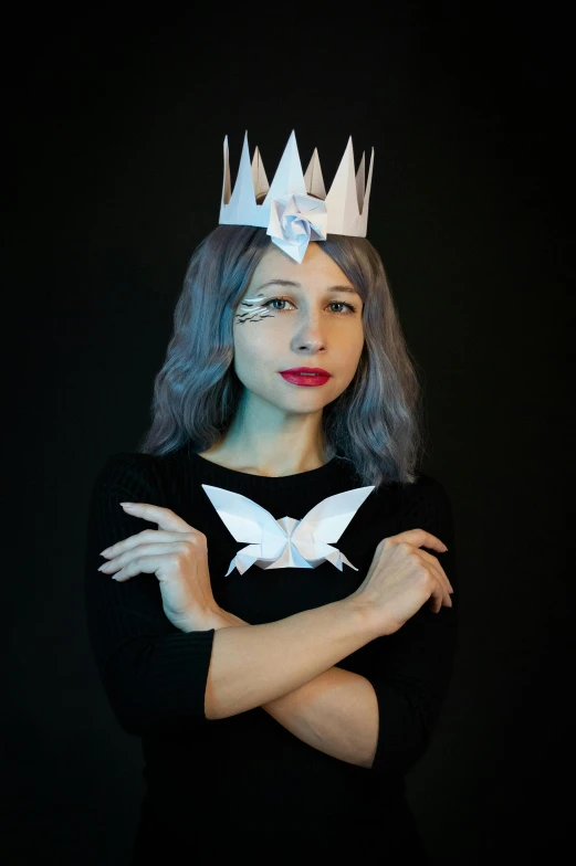 a woman with a crown on her head, inspired by Julia Pishtar, featured on reddit, origami, nonbinary model, silver wings, discord profile picture