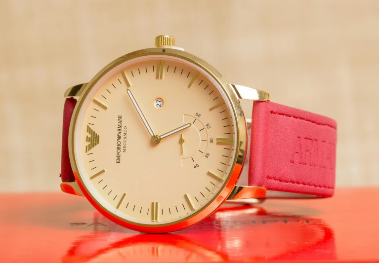 a close up of a wrist watch on a table, an album cover, pexels contest winner, pop art, armani, red and golden color details, pink, closeup - view