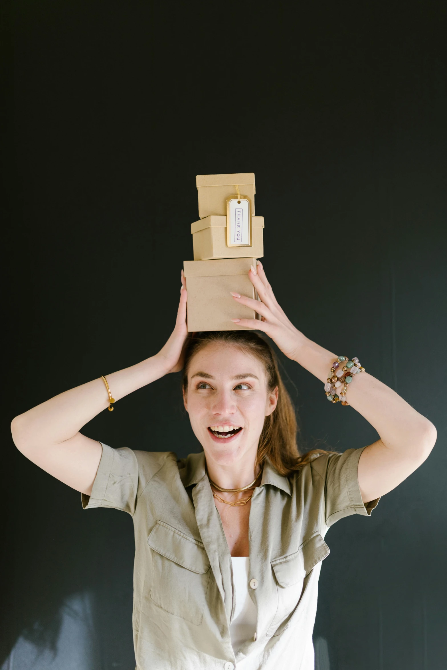 a woman holding a box on top of her head, a portrait, pexels contest winner, all overly excited, product introduction photo, stacked, jill stingray