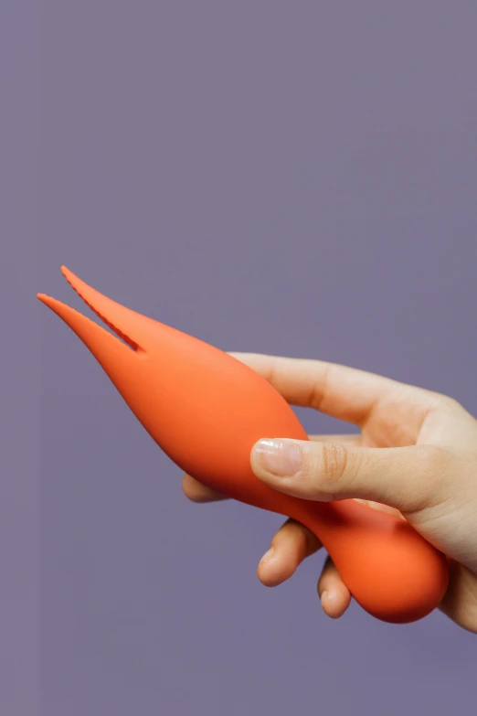 a close up of a person holding a toy carrot, long flowing fins, matte finish, entangled vibrating, coral red