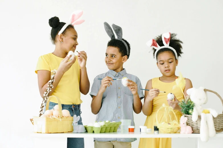 a couple of kids that are standing in front of a table, with an easter basket, profile image, flatlay, a group of people