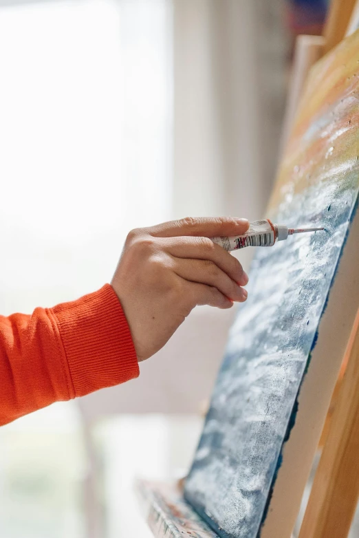 a close up of a person painting on a canvas, trending on pexels, fan favorite, paint knife, high detailed oilpainting, mid - shot