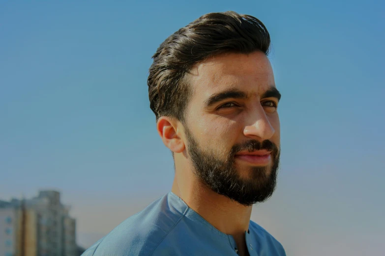 a man with a beard wearing a blue shirt, pexels contest winner, hurufiyya, lean man with light tan skin, middle eastern skin, profile image, avatar image