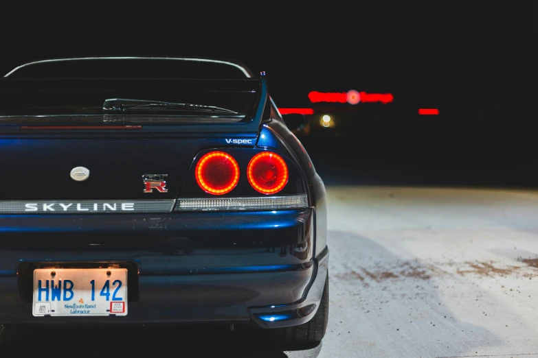 a car parked in a parking lot at night, pexels contest winner, in a modified nissan skyline r34, rear lighting, gauges, 2019 trending photo