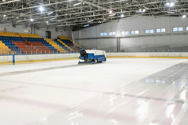 a man cleaning a hockey rink with a machine, by karlkka, spacious, glittering ice, empty stage, profile image