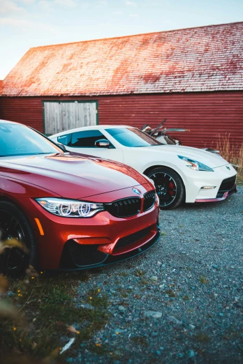 two cars parked next to each other in front of a barn, pexels contest winner, white and red color scheme, bmw, looking towards camera, profile image