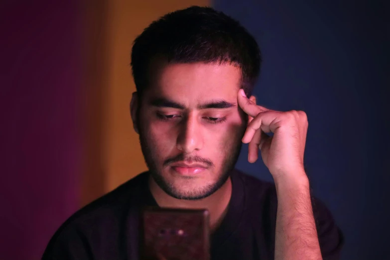 a man looking at his cell phone in the dark, a picture, hurufiyya, discord profile picture, with a sad expression, hziulquoigmnzhah, profile image