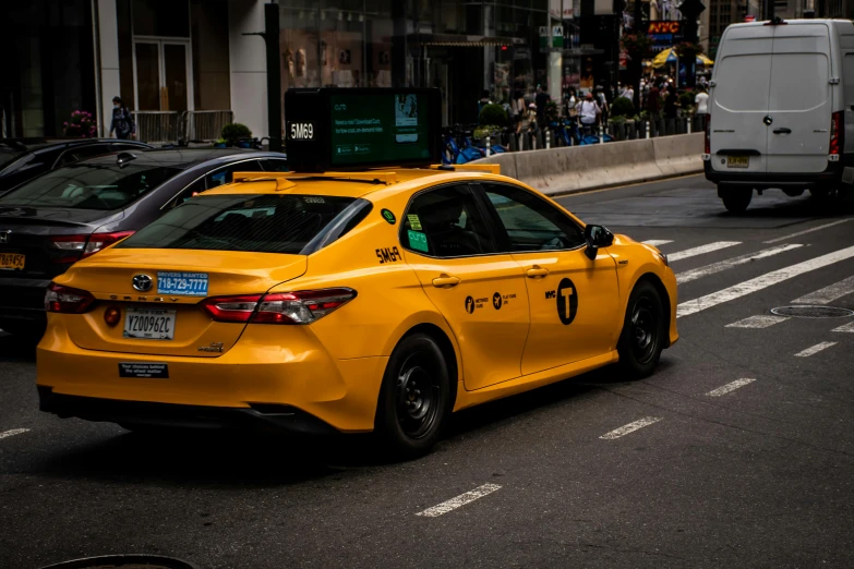 a yellow taxi cab driving down a city street, by Daniel Gelon, pexels contest winner, square, fan favorite, giants, side profile shot