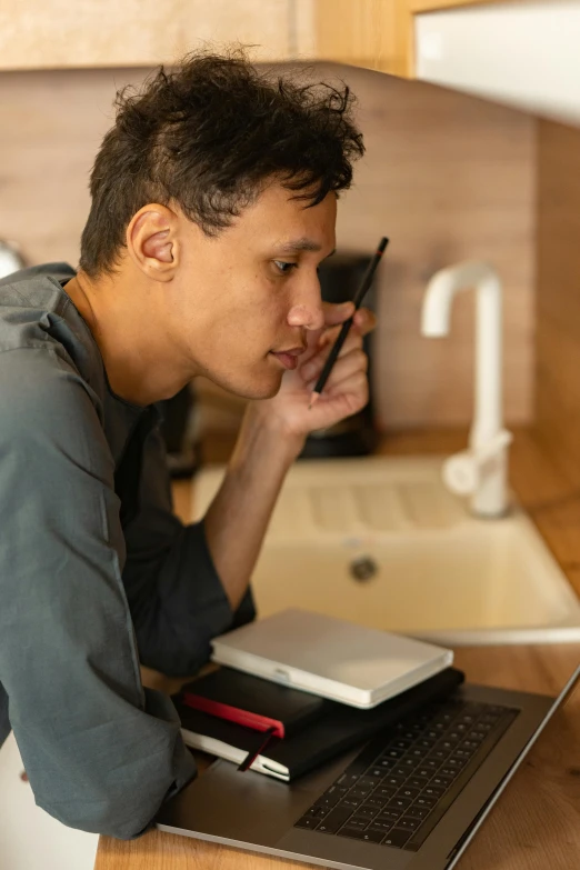 a man sitting at a kitchen counter talking on a cell phone, pexels contest winner, realism, holding notebook, draw with wacom tablet, profile image, asian male