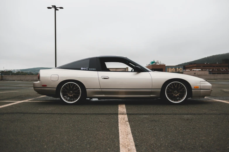 a white car parked in a parking lot, a portrait, unsplash, japanese drift car, soft top, fullbody photo, satin silver