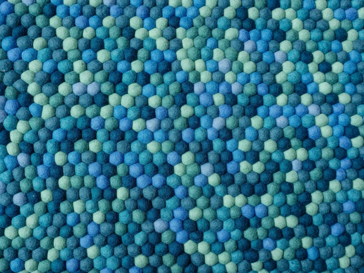a close up of a blue and green rug, honeycomb structure, volumetric wool felting, 256 colors, marbles