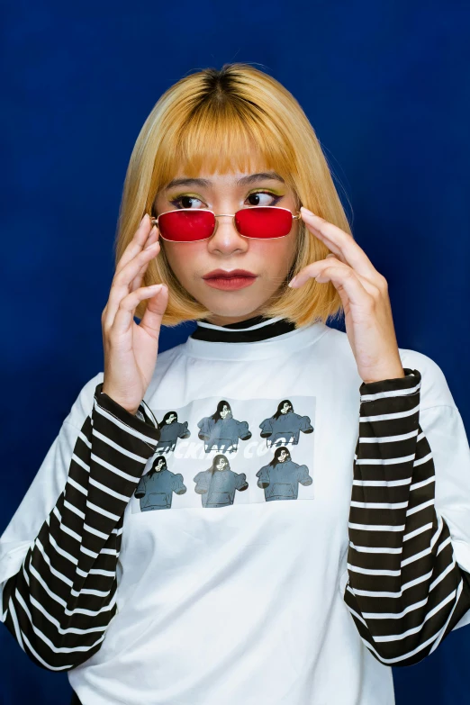 a woman holding a pair of red glasses in front of her face, an album cover, inspired by Shinoda Toko, featured on reddit, streetwear fashion, wearing stripe shirt, high resolution photo, whitebangs