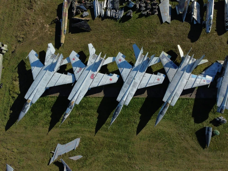 a group of fighter jets sitting on top of a grass covered field, by Attila Meszlenyi, pexels contest winner, auto-destructive art, isometric view from behind, metal wings, white, a wooden