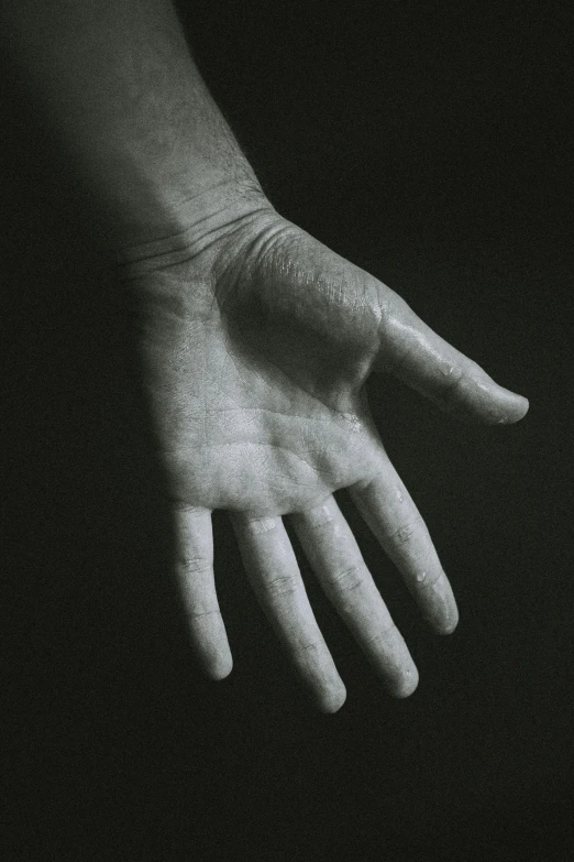 a black and white photo of a person's hand, paul barson, open palm, handcrafted, beaten