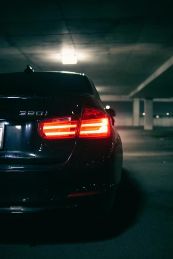 a car parked in a parking garage at night, pexels contest winner, bmw, rear lighting, instagram photo, back lit