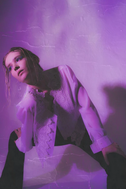 a woman posing in front of a purple background, inspired by Elsa Bleda, grimes, grainy, promotional image, pale light