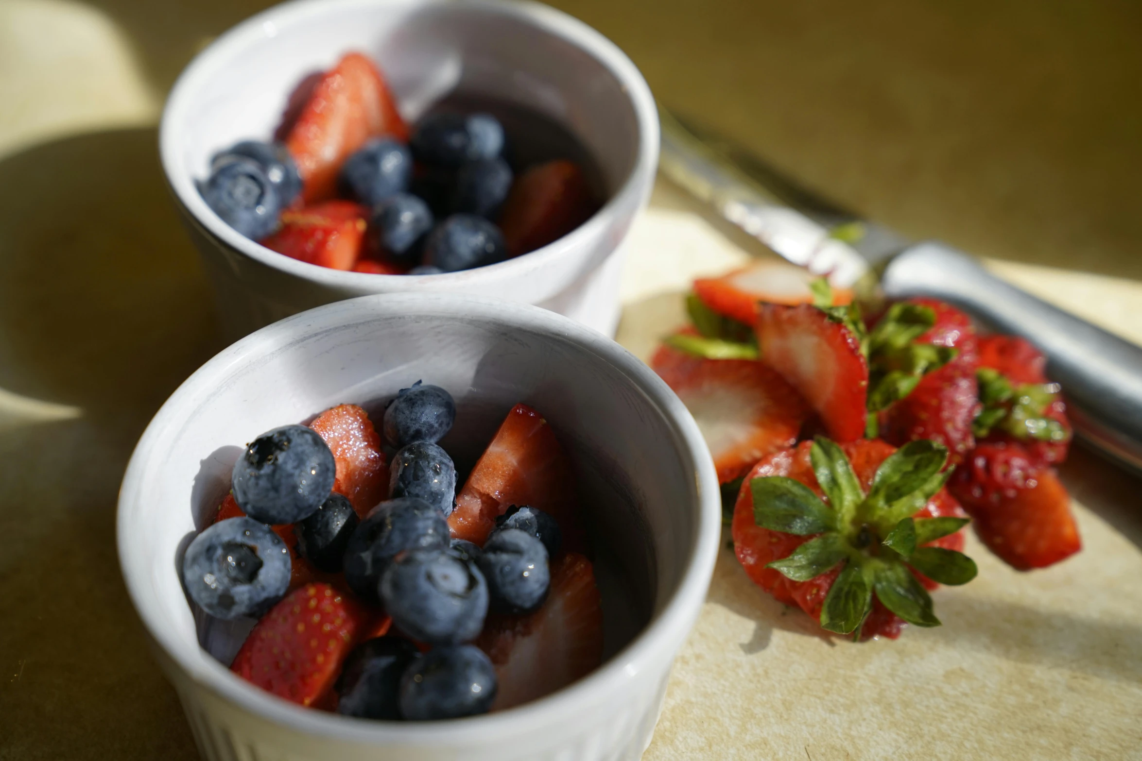 two bowls of strawberries and blueberries on a table, by Leo Michelson, pexels, maple syrup & hot fudge, short dof, cooked, mini model