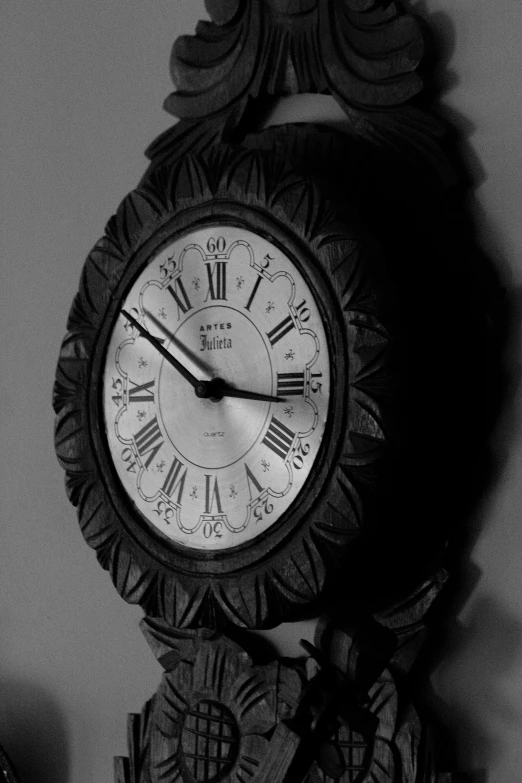 a black and white photo of a clock on a wall, by John Hutton, flickr, hand carved, server, watches, untitled