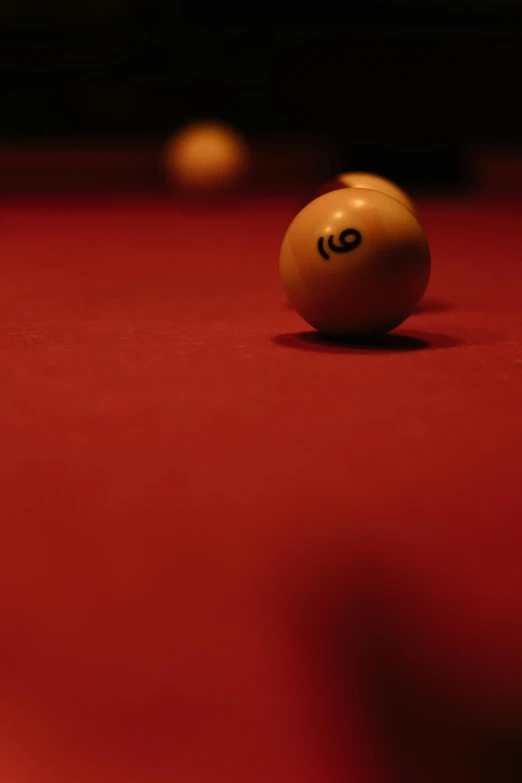 a billiard ball sitting on top of a pool table, red cloth, cinematic shot ar 9:16 -n 6 -g, maroon, hires