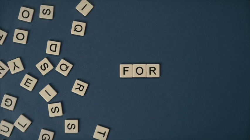 a bunch of scrabbles sitting on top of a blue surface, by Carey Morris, trending on unsplash, letterism, concrete poetry, stopmotion animation, background image, for 1 9 7 0 s'sci - fi