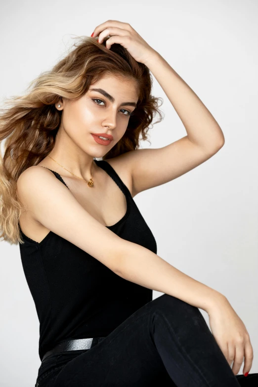 a beautiful young woman sitting on top of a chair, by irakli nadar, trending on pexels, black tank top, promotional image, wearing casual clothing, neck zoomed in