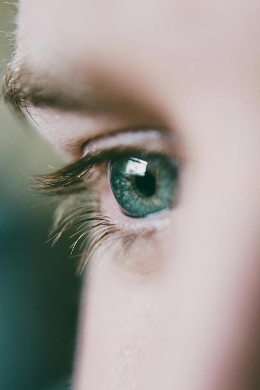 a close up of a person's green eye, trending on unsplash, instagram post, looking to the right, blue-eyed, noticeable tear on the cheek