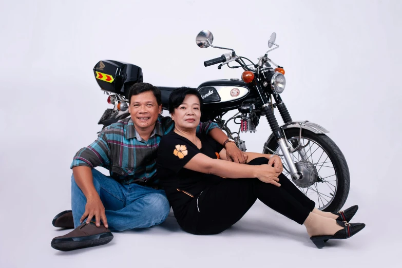 a man and a woman sitting next to a motorcycle, a portrait, by Yosa Buson, pexels contest winner, dau-al-set, plain background, momma and papa, mai anh tran, hero pose
