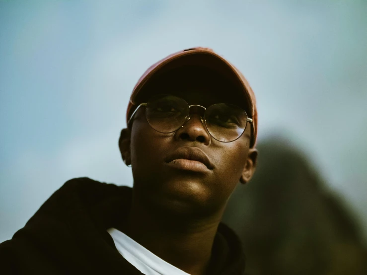 a close up of a person wearing a hat and glasses, pexels contest winner, black teenage boy, portrait of bald, landscape photo, yzy gap