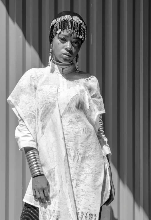 a black and white photo of a woman in a dress, inspired by Makoto Aida, afrofuturism, clothed in white shirt, african canadian, metal garments, photograph taken in 2 0 2 0