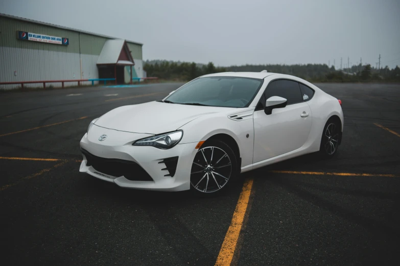 a white sports car parked in a parking lot, by Austin English, pexels contest winner, square, samurai vinyl wrap, front, medium height