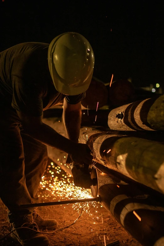 a man that is working on some kind of thing, flickr, ap news photograph, energy, during night, cut