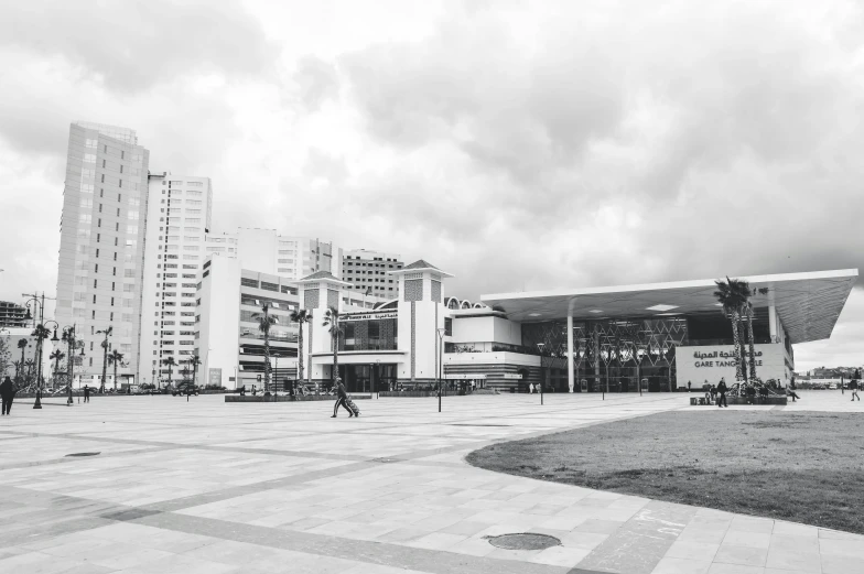 a black and white photo of a city square, by Alejandro Obregón, pexels contest winner, brutalism, south jakarta, smooth white surroundings, mall background, outdoor fairgrounds