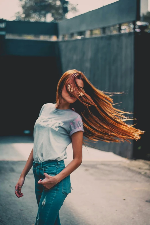 a woman riding a skateboard down a street, pexels contest winner, renaissance, long ginger hair windy, the wind moves her shirt, portrait featured on unsplash, dancing gracefully