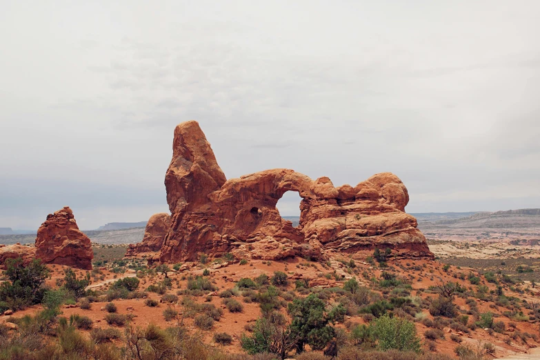 a large rock formation in the middle of a desert, a photo, by Morgan Russell, unsplash contest winner, visual art, gothic arch frame, 2000s photo, 🦩🪐🐞👩🏻🦳, stephen shore