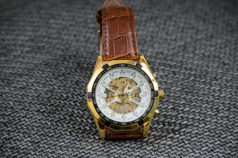 a close up of a watch on a cloth, inspired by Henry Otto Wix, pixabay, renaissance, brown exoskeleton, gold trim, steampunk stormtrooper, three - quarter view