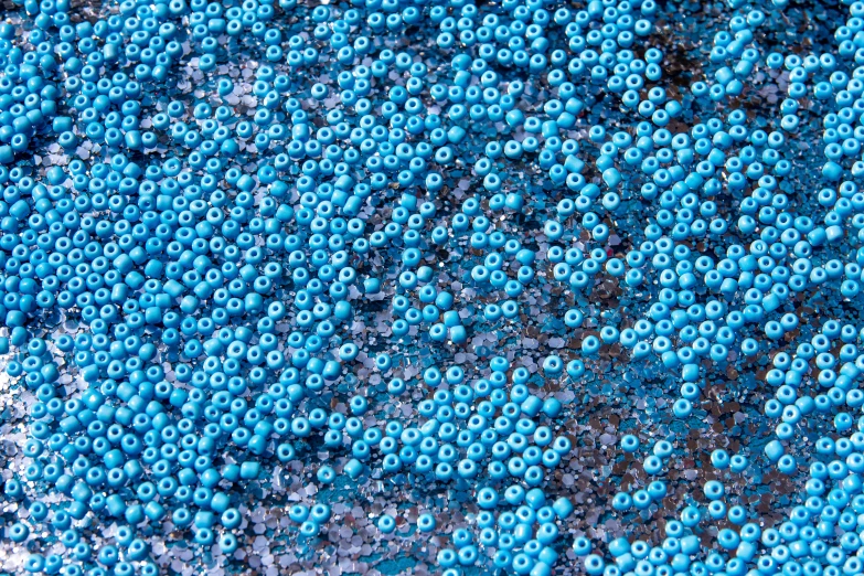 a close up of a bunch of blue beads, a macro photograph, by Howardena Pindell, reddit, pointillism, fairy circles, textured base ; product photos, lightblue acrylic paintdrip tar, kitbash 3 d texture vibrant