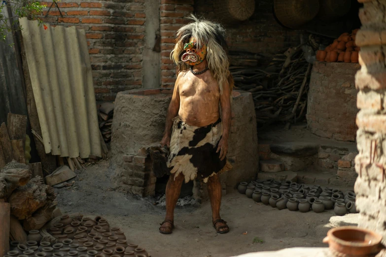 a man that is standing in the dirt, a portrait, pexels contest winner, sumatraism, full body with costume, standing outside a house, loin cloth, full mask