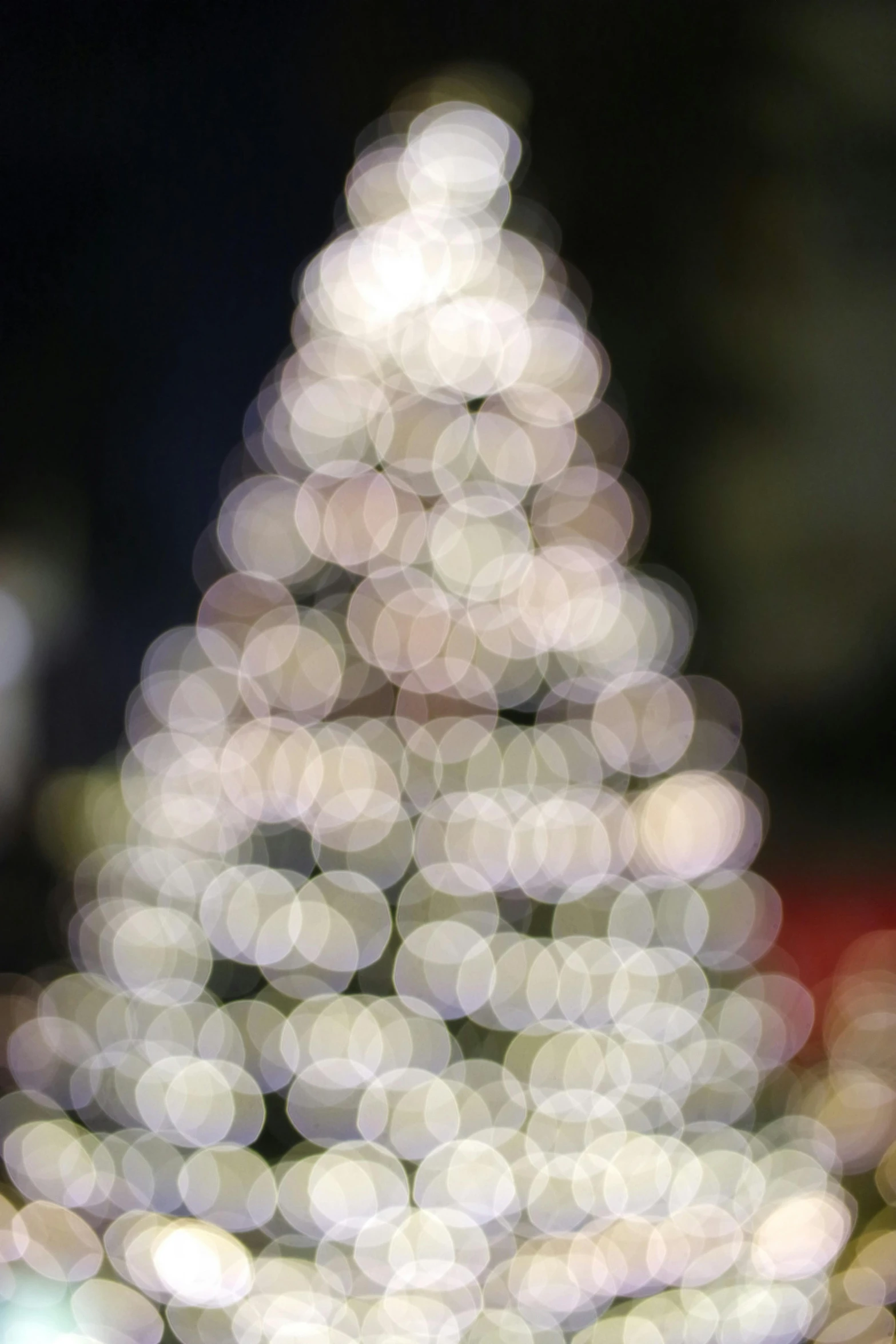 a blurry image of a christmas tree, dappled silver lighting, light circles, giant white tree, 4 5 mm bokeh