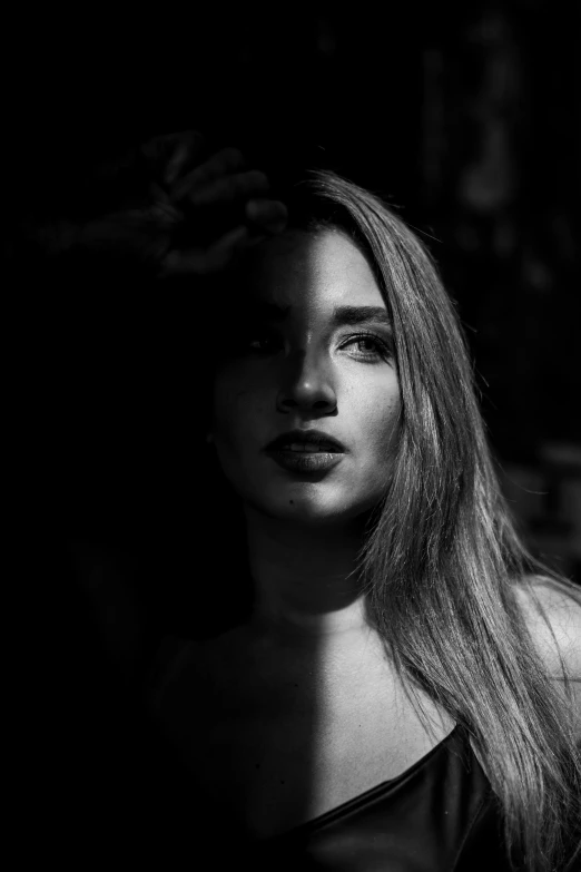 a black and white photo of a woman, by Alexis Grimou, pokimane, contrasting lighting, light and dark, of a young woman