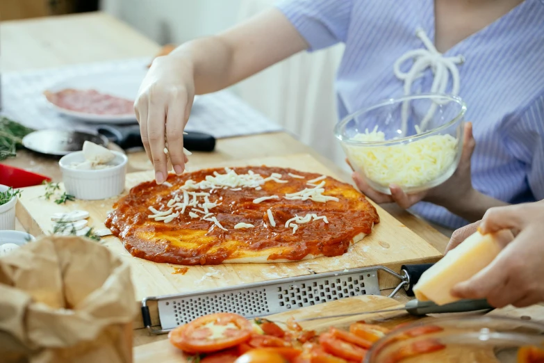 a person cutting a pizza on a cutting board, by Julia Pishtar, straya, ellie bamber, extra cheese, in style of pan ren wei