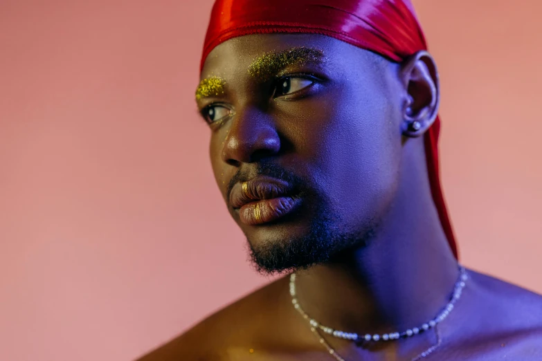a man with a red bandana on his head, by Julia Pishtar, trending on pexels, afrofuturism, delicate androgynous prince, wearing gilded ribes, male model, roygbiv