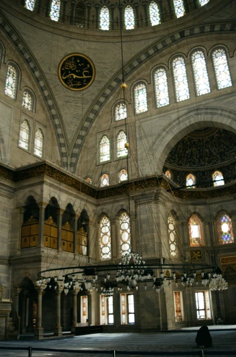 the inside of a large building with many windows, inspired by Osman Hamdi Bey, black domes and spires, grey