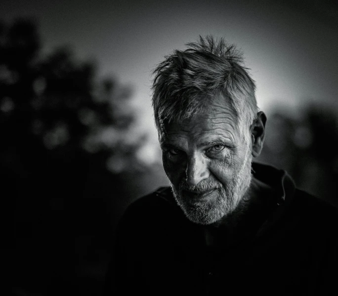 a black and white photo of a man with a beard, a black and white photo, pexels contest winner, frail, taken at golden hour, zombie with white eyes, portrait photo of an old man