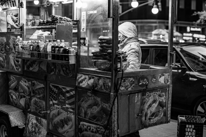 a black and white photo of a street vendor, by Emma Andijewska, cold freezing nights, snake machine, having a snack, square