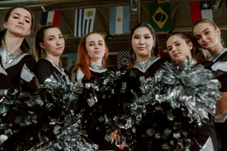 a group of women standing next to each other holding pom poms, pexels contest winner, antipodeans, black and silver, argentina flags behind, in the high school gym, avatar image