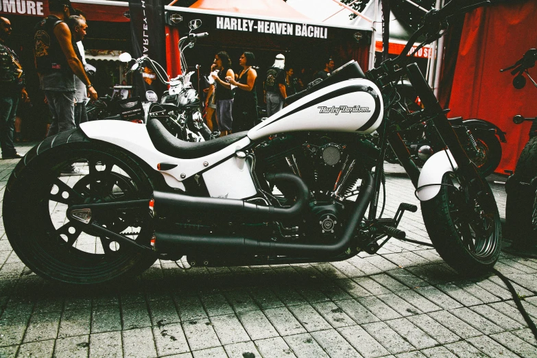 a white motorcycle parked on the side of a street, pexels contest winner, photorealism, cosplay on black harley queen, 🚿🗝📝, in sao paulo, concert