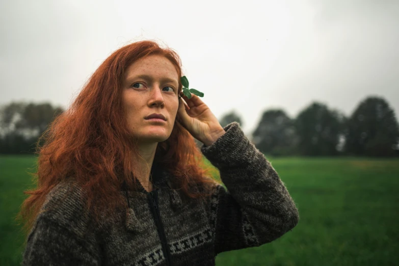 a woman with red hair talking on a cell phone, an album cover, inspired by Louisa Matthíasdóttir, unsplash, renaissance, farmer, clover, 2022 photograph, ((portrait))