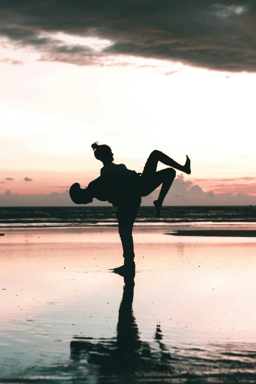 a person doing a handstand on a beach, pexels contest winner, romanticism, couple kissing, anthropomorphic silhouette, in a jumping float pose, doing a sassy pose