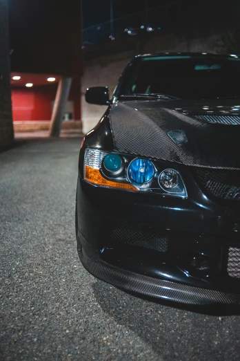 a black car parked in a parking lot at night, sleek blue visor for eyes, '0 0 s nostalgia, alterd carbon, detail shots