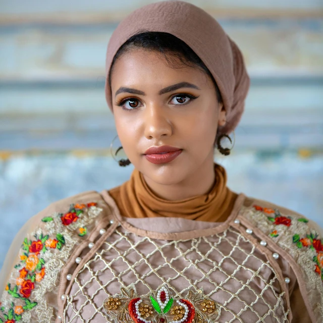 a woman in a hijab poses for a picture, an album cover, trending on pexels, she has olive brown skin, wearing ornate clothing, portrait 8 k, teenager girl